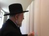 Rabbi Lau, Chairman of the Yad Vashem Council, looking at the Book of Names at the new permanent exhibition SHOAH in Block 27 at Auschwitz-Birkenau